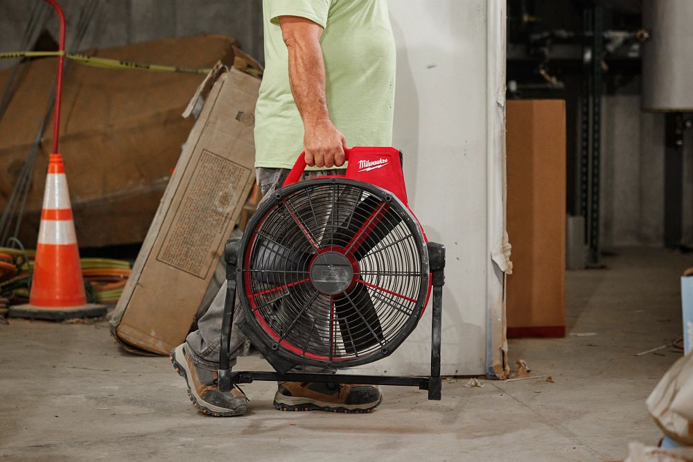 Man carrying Milwaukee Fan