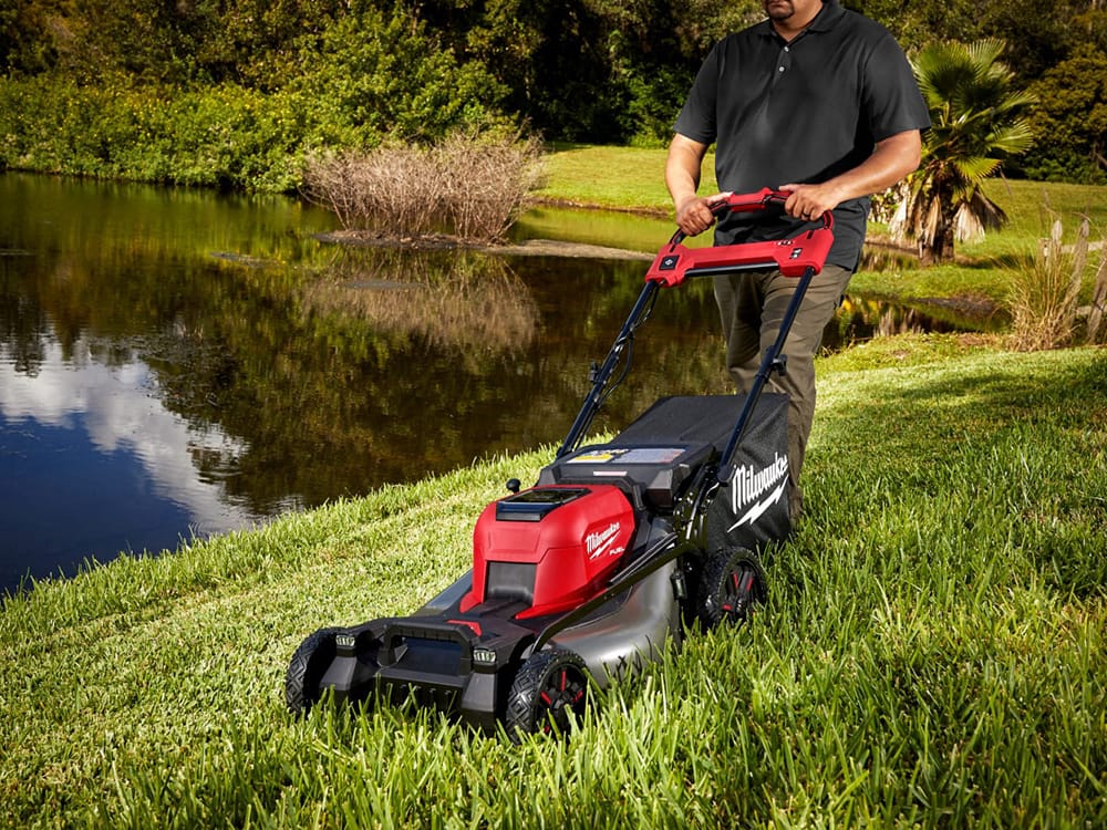 Milwaukee M18 Lawn mower being used near a lake